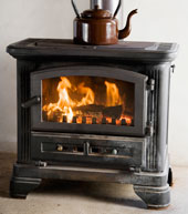 black wood stove with fire burning in it