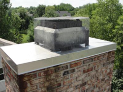 brick chimney on roof with metal chimney cap