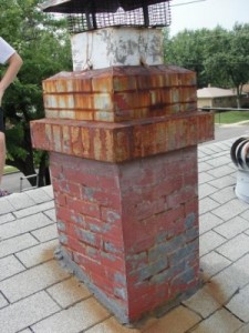 older brick masonry chimney with chimney cap in need of repair