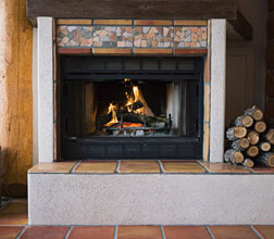 white and stone fireplace with gas insert inside