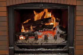 close up of fire in fireplace with ashes
